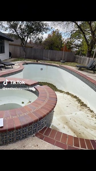 Exclusive created a completely new pool and backyard experience for this family. Starting with a modern concrete deck, we resurfaced to pool with a unique blue plaster, formed a convenient sitting ledge next to the hot tub, and accentuated everything with brilliant blue tile work. The pool is now the state-of-the-art -- with new Jandy equipment and AquaLink technology. This gives full control at their fingertips, every facet of pool functions controlled with an elegant smartphone app.#poolsoftik
