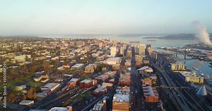 A Stunning Scenery in Tacoma, Washington With Different Buildings and Calm Sea During Sunrise - Aerial Shot