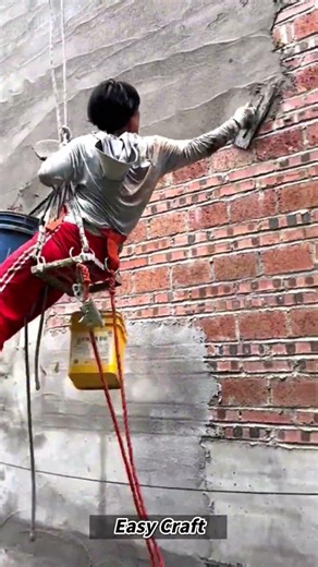 Vertical Wall Plastering via Rope Suspension