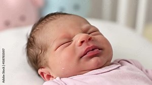 Crying baby with closed eyes mouth open and visible tears on its cheek
