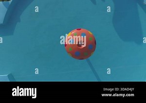 Colorful beach balls floating in pool