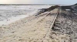 There's a railway line under there somewhere, sulphur creek hammered by big wind-driven seas | ABC Northern Tasmania