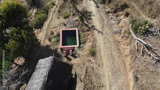 Footage of a remote village using solar system to lift water into irrigation ponds. Highlights renewable energy, agriculture support, and sustainable rural development.
