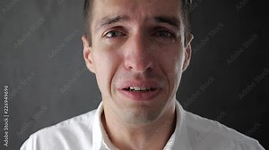 Portrait of sad man crying with tears in eyes. Depressed businessman crying. Man in despair.