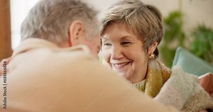 Love, retirement and senior couple kissing on a sofa in the living room of their home together for romance. Smile, relax or hug with an elderly man and woman embracing for affection in their house
