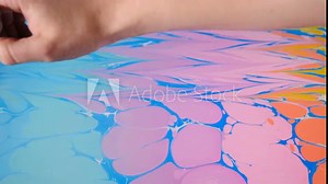 Ebru art. Painting technique. Female artist painting ebru technique - art on water. Drawing with brush followed by paper prints. Colorful paints with waves. Hobby, arts, culture concept. 4k Stock Video