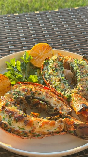 Grilled Lobster Tail with Garlic Butter 🦞🍋 | So Juicy and Easy! Make restaurant-style grilled lobster tails at home! Juicy, buttery, and full of garlic-lemon flavor — this easy recipe is perfect for a romantic dinner or weekend BBQ. Ingredients: • 2 warm water lobster tails (about 9 oz each) • Salt and pepper to taste • 2–3 garlic cloves, minced • 1 tbsp chopped parsley • 50–60 g butter • Olive oil (to drizzle) • 1 whole lemon (for grilling) Instructions: 1. Cut the lobster shell on top with k