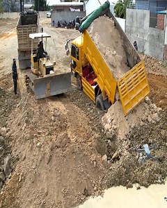 Truck Stuck Skillful Operation: Komatsu D31P Dozer Tackles Landfill and Mud Clearing by the Fence . . #Dozer #Bulldozer #heavyequipment #construction #Shantui #Komatsu #Dumptruck #Excavator #constructionsite #heavyduty #earthmoving #caterpillar | Bulldozer Cambodia