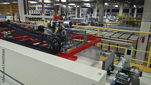 The preparation of empty cans entering the production line with a robotic arm in a fully automated filling factory Stock Video