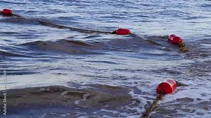 Blue water waves ocean with buoy buoys ropes nets Mexico.