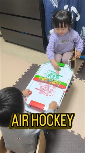 Three-year-old twins face off in a Super Mario air hockey match?!