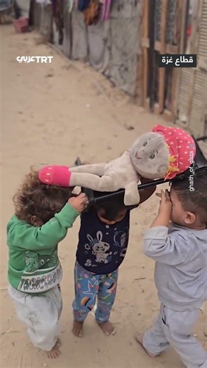 Children in Gaza reenact a martyr's funeral with a doll.