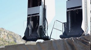 Grape harvesting machine discharging the load on a transport unit. Grape harvester unloading grapes in vineyard. Red grapes being machine picked. Agriculture. Stock Video