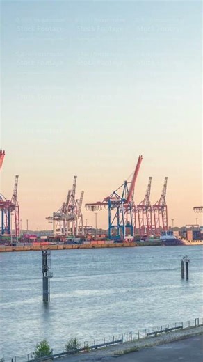 Aerial timelapse of Hamburg cargo port at sunset, showcasing container terminals, cranes and cargo
