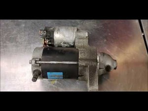 Where is the starter motor located in the Toyota Yaris?