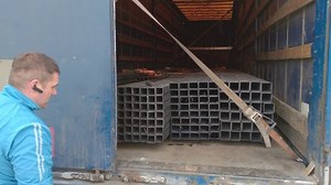 Man closes a wagon trailer slow motion outdoors