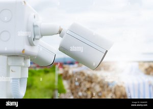 Side view of white CCTV security camera video system for safety at a paper recycling factory. Closed-circuit television. CCTV electronic security Stock Photo - Alamy