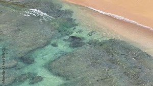 Aerial Tunnels Beach ocean sand Kauai Hawaii overhead. Surfing and swimming recreation. Kauai is the garden Isle. Economy is tourism based. Tourist enjoy beach and warm climate.