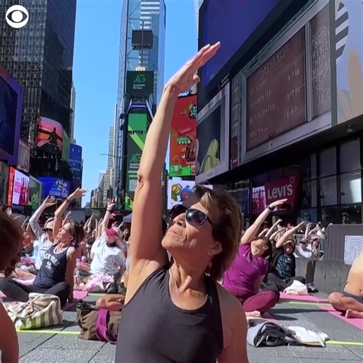 1.5K views | SUMMER YOGA: Thousands of people gathered to do yoga together in New York City's Times Square in honor of the summer solstice, marking the official start of summer on Friday (6/20). The annual event "Solstice in Times Square: Mind over Madness Yoga" started 23 years ago and offers free yoga sessions during the day. The celebration also comes one day ahead of the International Day of Yoga. | CBS Newspath | Facebook