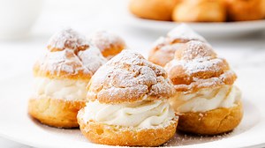 Golden, airy cream puffs made easy at home with crisp shells and fluffy cream filling.