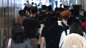TOKYO, JAPAN - JULY 2023 : Crowd of people walking at the street near Shinjuku station in busy rush hour. Japanese people, urban city life and lifestyle concept, 4K video.