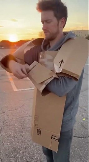 Cardboard Superhero Assembles DIY Armor at Sunset
