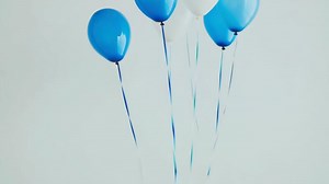 Download Colorful balloons floating against a light background for free