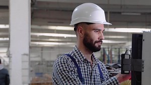 Industrial programmer checking control box status with computer
