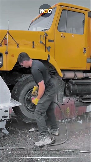 Lifting heavy truck with loader bucket for wheel replacement without hydraulic jack