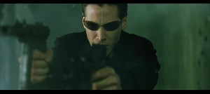 In the lobby shootout scene from The Matrix, Neo (Keanu Reeves) dual wields and shoots two Sa vz. 61 Skorpion SMGs that's chambered in .32 acp a pistol caliber, yet the empty cartridges thats falling on the floor are from 5.56x45mm rifle caliber cartridges.