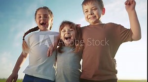 group of kids team hugging jumping and rejoicing outdoors. happy family teamwork kid dream concept. family children sisters brothers have fun hugging in the park in nature sun