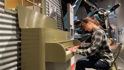 Piano restorer/artist/Victory Vertical expert Jordan Cook keeps the Victory Vertical pianos tuned and in good shape while they are on exhibit here. Relax a few minutes and watch her taking care of "Evie" the olive drab piano, followed by her performance with a Corsair in the background! (She also has program at the Museum Aug. 23 at 11 a.m. | The Museum of Flight