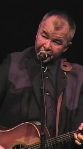John performing "Sam Stone"