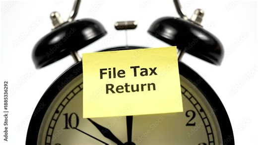 Alarm clock with "File Tax Return" note