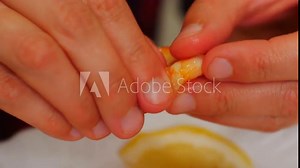 Patient in Nutrition Clinic. Boiled shrimp in shell. Woman peels shrimp from shell and eats them. Japanese low-calorie diet for longevity