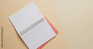Overhead view of open notebook with pink marker with copy space on beige background, in slow motion Stock Video
