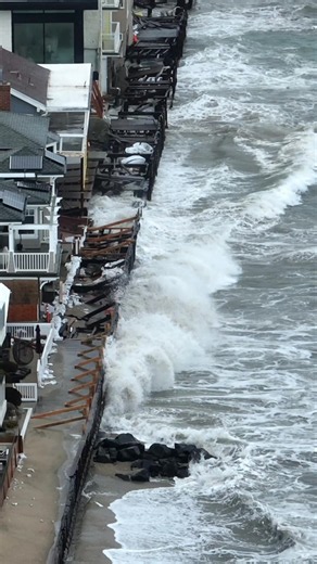 Long Beach: Aerial View of Waves Crashing on Damaged Properties