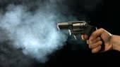 Revolver shooting and smoking, slow motion