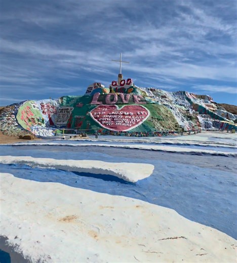 Climbing the strangest mountain in the middle of the desert called Salvation Mountain in Slab City | Exploring with Josh