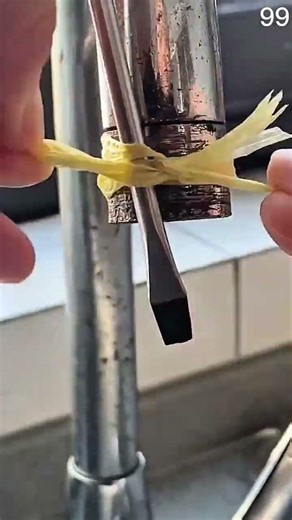 Wrapping yellow plumber’s tape around pipe threads for watertight seal