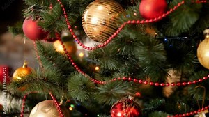 Paning 4k footage of camera moving along beautiful decorated christmas tree with colorful babubles and lights