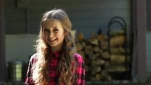 clip-7970644-tween-girl-poses-front-her-home-property