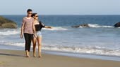 Couple walking on beach together