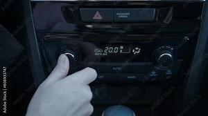 Lady control car temperature. A view of woman finger press the button to start the air condition during driving time.