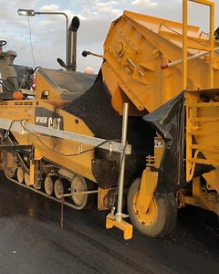 BuildWitt with footage of highway paving using belly dump trucks and an elevator | Daily Construction