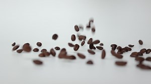 Download Coffee on white background, slow motion of coffee beans for free