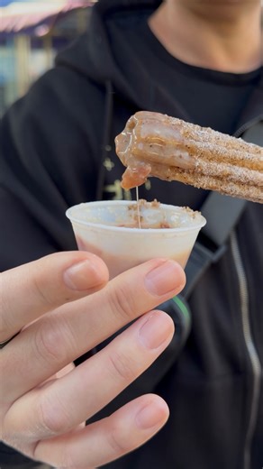 Disneyland Holiday Churro with maple and bacon dipping sauce! It has a great sweet and salty flavor. Rating: 8/10 🍩 Get it at the churro stand in Tomorrowland near Buzz Lightyear Astro Blasters through Jan. 7. | David Vaughn