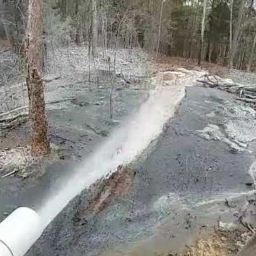 Well Drilling Rig Hitting Big Water in a Rock Well