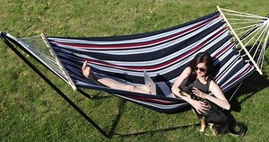 clip-1053668210-young-woman-short-dress-sunglasses-laying-hammock