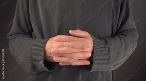 Thumb twiddling, male hands twiddling fingers as an example of time-wasting useless activity, close up selective focus, 4k uhd 2160p footage.